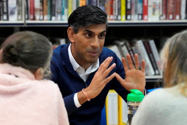 Britain's Prime Minister Rishi Sunak speaks to an adult learning group at Clacton-on Sea library, during a visit to Clacton-on-Sea, south east England, on October 18, 2023. (Photo by Frank Augstein / POOL / AFP)