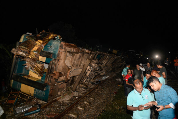 A general view of derailed compartments of train after two trains collided in Bhairab