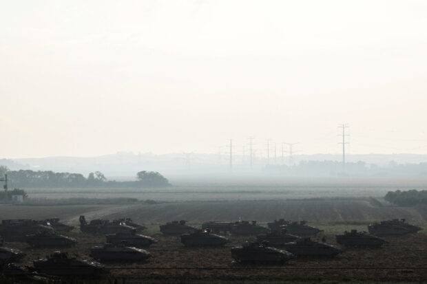sraeli tanks and military vehicles take position near Israel's border with the Gaza Strip, in southern Israel, Oct. 14, 2023. 