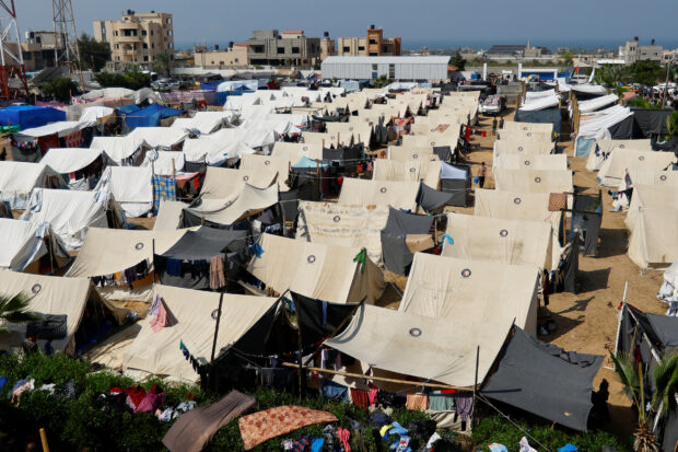 Palestinians take shelter in a tent camp at a United Nations-run centre in Khan Younis