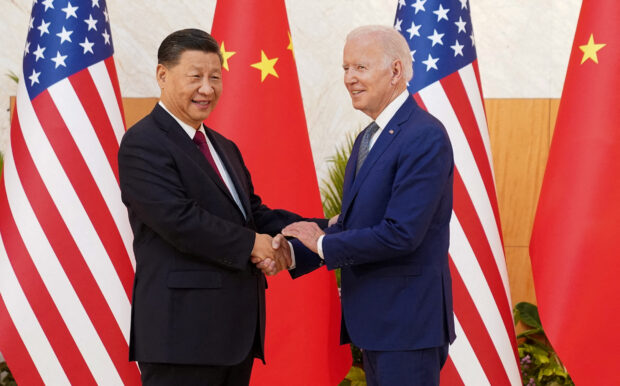 U.S. President Joe Biden shakes hands with Chinese President Xi Jinping as they meet on the sidelines of the G20 leaders' summit in Bali, Indonesia, November 14, 2022.  REUTERS/Kevin Lamarque/File Photo