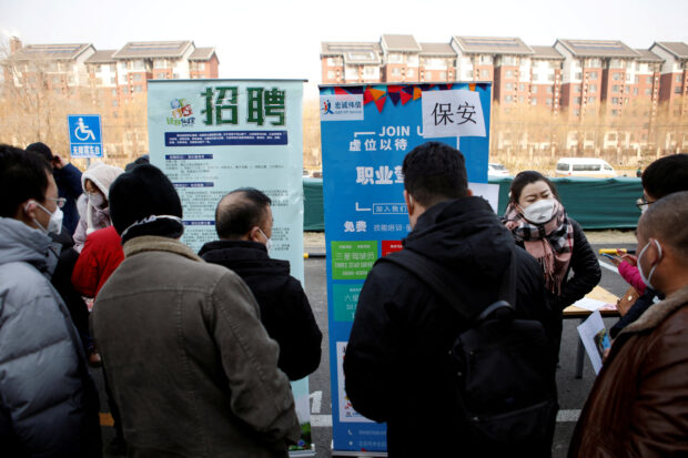 FILE PHOTO: Job seekers attend a job fair in Beijing, China February 16, 2023. REUTERS/Florence Lo/File Photo/File Photo