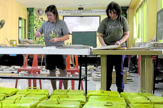 ELECTION PREP Personnel from the Manila City Treasurer’s Office help prepare ballot boxes and other election materials at Tondo High School on Oct. 29, the eve of the barangay and Sangguniang Kabataan polls. —RICHARD A. REYES