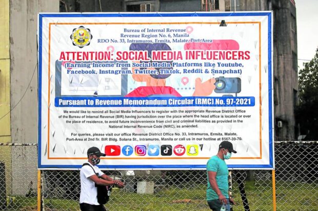 DULY NOTIFIED As early as Oct. 26, 2021, during the Duterte administration when this photo was taken, the Bureau of International Revenue announced its plans to tax social media influencers in this sign put up along Roxas Boulevard in Manila. —LYN RILLON