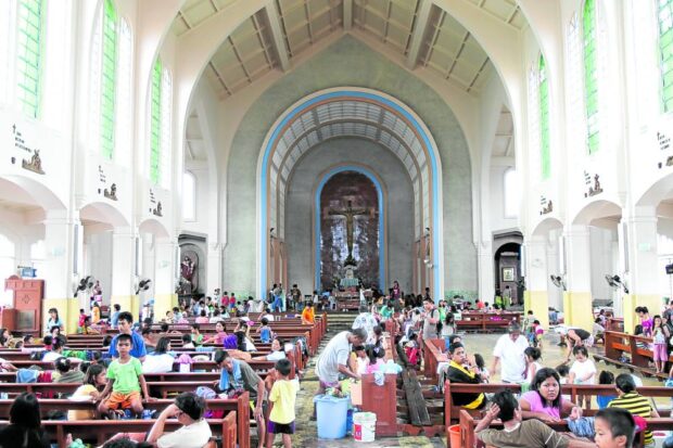 CHURCH AS SANCTUARY The Our Mother of Perpetual Help Church (Redemptorist) in Tacloban City became a sanctuary for victims of Supertyphoon “Yolanda” (Haiyan) in 2013 (left). At right, the church in a photo taken on Tuesday, 10 years after Yolanda inundated and devastated the city. —PHOTOS BY NIÑO JESUS ORBETA