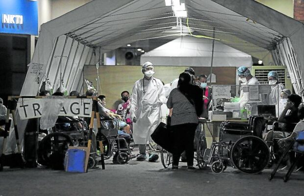 PANDEMIC PANDORA’S BOX National Kidney and TransplantInstitute workers tend to patients at a triage tent during the pandemic, which laid bare the sorry state of the country’s health system. —GRIG C. MONTEGRANDE