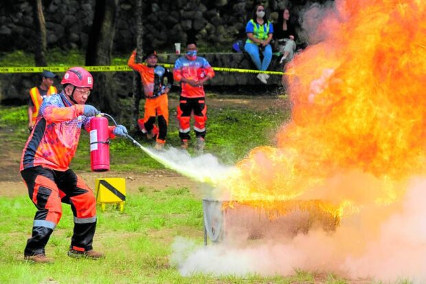 SAFETY IS PRIORITY A mine worker on Friday tests his skill at stopping fires in their worksites during a competition held as part of this year’s National Mine Safety and Environment Conference inBaguio City. —NEIL CLARK ONGCHANGCO