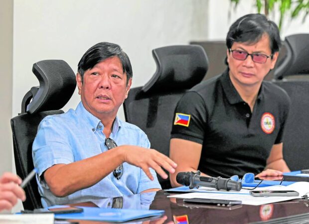 SITUATIONAL BRIEFING President Marcos is joined by Interior Secretary Benhur Abalos (right) and other officials in Tacloban City on Thursday for a briefing on the impact of widespread flooding in Eastern Visayas this week. —PPA POOL