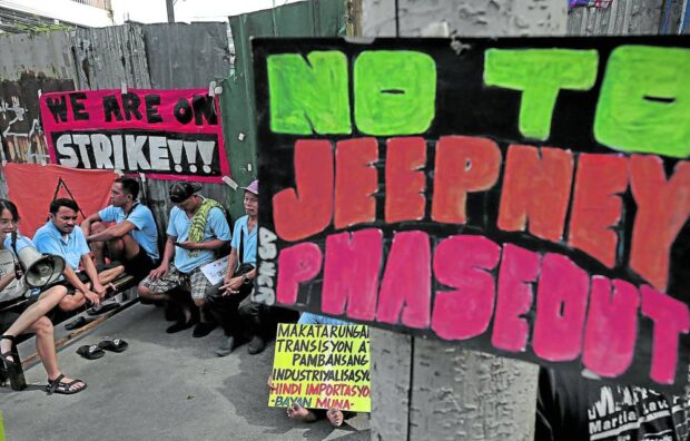 AGAINST MODERNIZATION  Public utility vehicle drivers protest at a jeepney terminal in Manila. —RICHARD A. REYES 