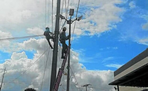Linemen of Agusan del Sur Electric Cooperative (Aselco) are taking down cables attached to its 69 KV transmission line post during the start of "Task Force Operation Baklas" on Nov. 20, including the fiber optic cable of the Philippine Long Distance Telephone Company. PHOTO COURTESY OF ASELCO 