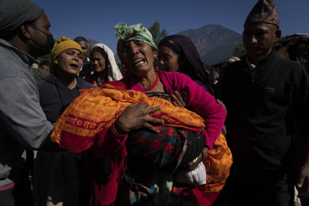 Nepal villagers cremate loved ones who perished in an earthquake that killed 157 people