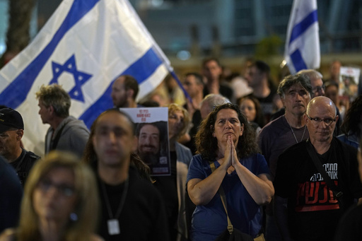 People participate in a show of solidarity with hostages being held in the Gaza Strip, near the Museum of Art in Tel Aviv, Israel, Saturday, Nov. 25, 2023. Egyptian officials said Hamas was preparing to release 14 Israeli hostages Saturday for 42 Palestinian prisoners held by Israel. (AP Photo/ Leo Correa)