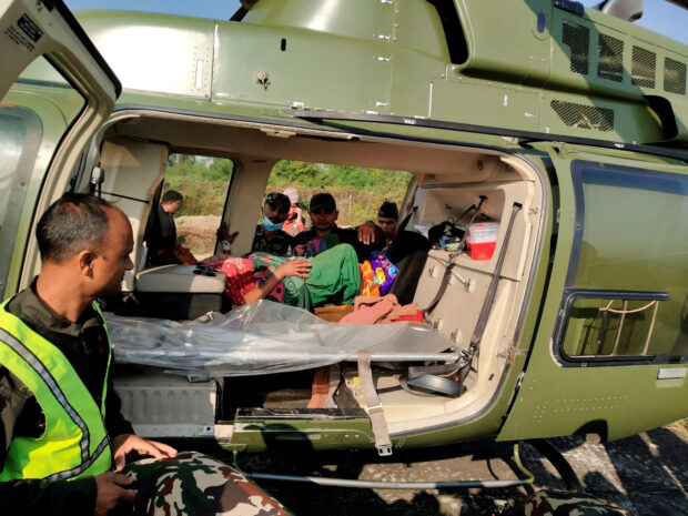An injured person is seen inside a helicopter after an earthquake in Jajarkot, Nepal, November 4, 2023.