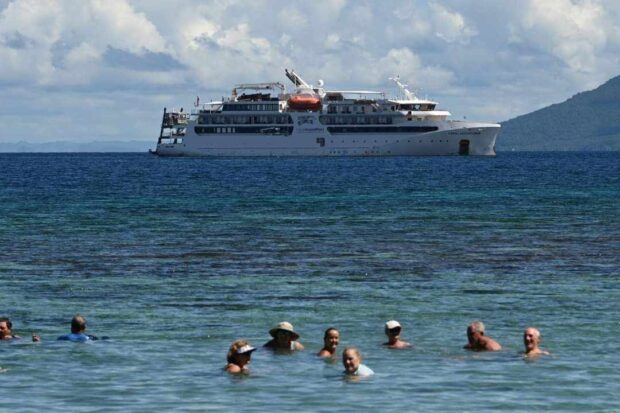 REFRESHING DIP Foreign tourists enjoy the beach in Biri, Northern Samar, as the Australian cruise ship Coral Adventurer makes a port call in Eastern Visayas on Wednesday. —PHOTO COURTESY OF THE DEPARTMENT OF TOURISMIN EASTERN VISAYAS