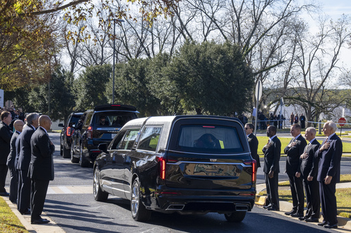 Former and current U.S. Secret Service agents assigned to the Carter detail, stand with their hands over their hearts as the casket of former first lady Rosalynn Carter departs Phoebe Sumter Medical Center in Americus, Ga., Monday, Nov. 27, 2023. The former first lady died on Nov. 19. She was 96. (AP Photo/Alex Brandon, Pool)
