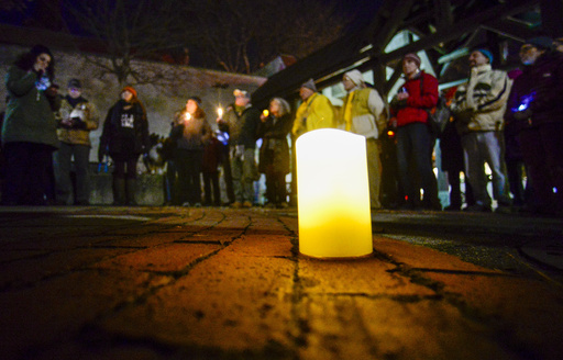 People gather in Pliny Park in Brattleboro, Vt., for a vigil, Monday, Nov. 27, 2023, for the three Palestinian-American students who were shot while walking near the University of Vermont campus in Burlington, Vt., Saturday, Nov. 25. The three students were being treated at the University of Vermont Medical Center, and one faces a long recovery because of a spinal injury, a family member said. (Kristopher Radder/The Brattleboro Reformer via AP)