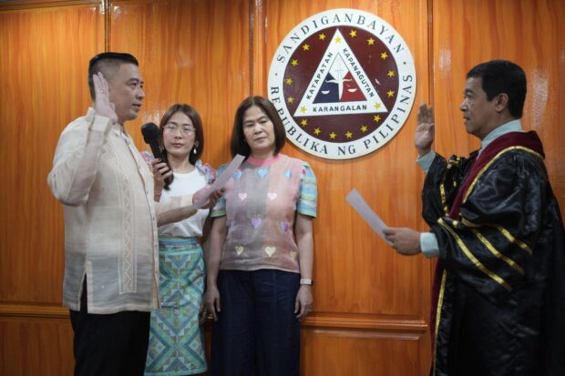 (Left to Right) Cong. Roberto "Pinpin"Uy, Jr. takes his oath before Sandiganbayan Associate Justice Edgardo Caldona while his family, Shaia and Robinette Uy, looks on. Contributed photo
