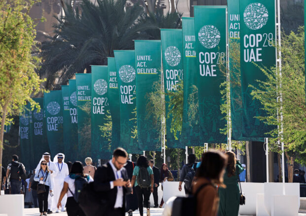 Delegates walk at the United Nations Climate Change Conference COP28 in Dubai, United Arab Emirates, December 8, 2023. REUTERS/Thaier Al Sudani/File Photo