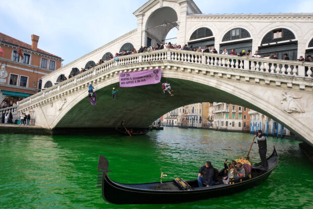 Italian climate change protesters turn Venice's Grand Canal green