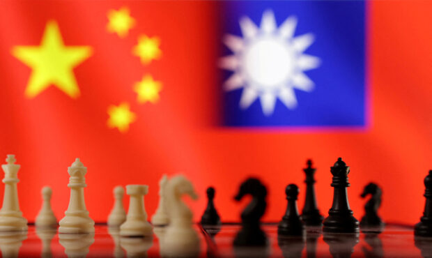 Chess pieces are seen in front of displayed Chinese and Taiwanese flags in this illustration taken, April 11, 2023. REUTERS/Dado Ruvic/Illustration/File Photo