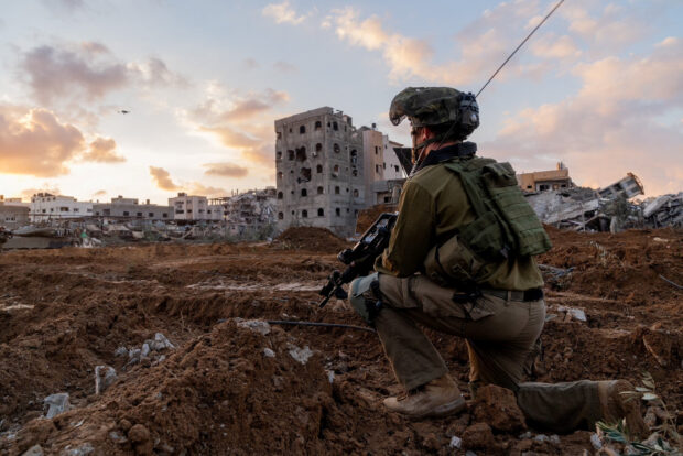 Israeli soldier takes position in the Gaza Strip, amid the ongoing conflict between Israel and the Palestinian Islamist group Hamas, in this handout picture released on December 27, 2023. Israel Defense Forces/Handout via REUTERS