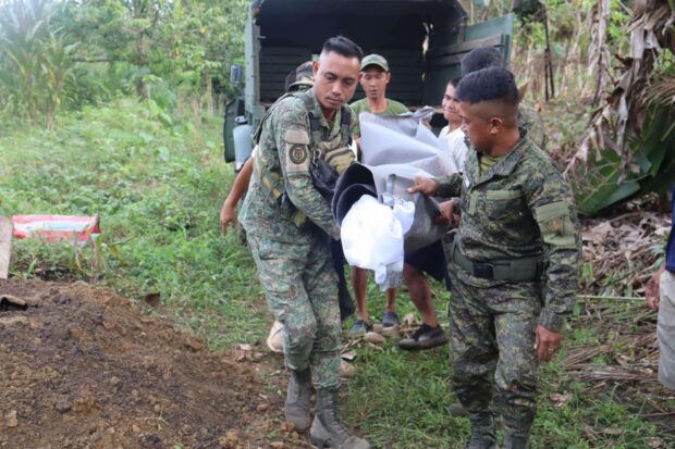 Soldiers turn over the remains of slain Abu Sayyaf leader Mudzimar Sawadjaan to the local government in Basilan for proper Islamic burial. 