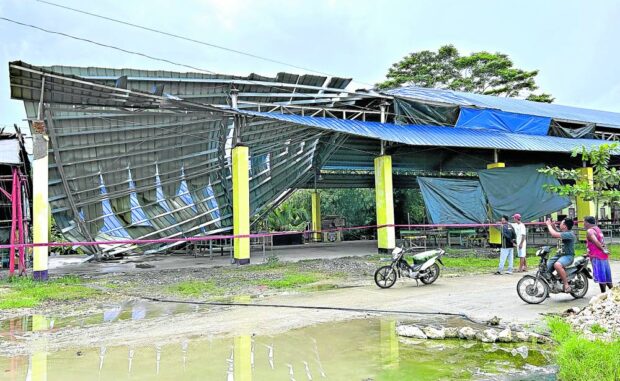 QUAKE AFTERMATH Twisted metals are what remained of a multipurpose building in Tagbina town, Surigao del Sur.  —PHOTO BY ERWIN MASCARIÑAS