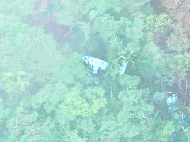 TRAGIC SIGHT A Philippine Air Force Sokol helicopter captures an image of the wreckage of the RP-C1234 Piper plane at Barangay Casala in San Mariano, Isabela on Tuesday during an aerial survey but operations to reach the crash site and search for the two occupants were halted by poor weather. —PHOTO COURTESY OF INCIDENT MANAGEMENT TEAM-ISABELA