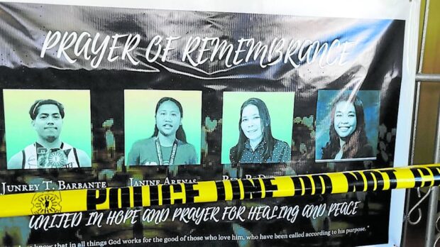 PRAYER OF REMEMBRANCE A tarpaulin bearing the images of the four persons who died in the Dec. 3 bombing inside the gymnasium of Mindanao State University is mounted outside the gym to honor their memory, as classes resume in the university on Dec. 10. —RICHEL V. UMEL