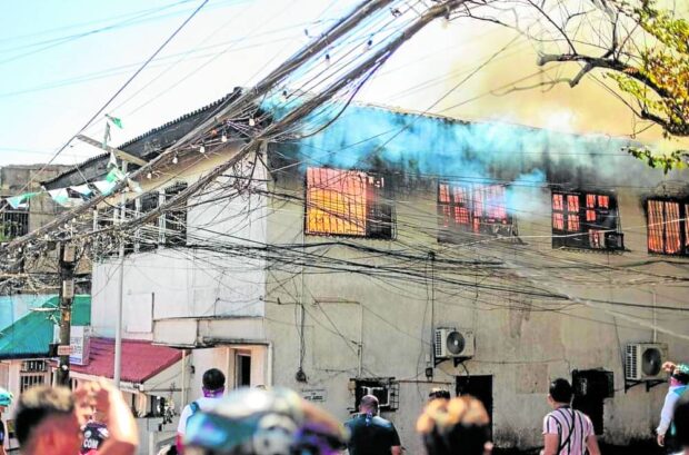 IN FLAMES   The municipal trial court of Minglanilla town, Cebu, is engulfed in fire after a court employee allegedly set it ablaze on Tuesday.  —CONTRIBUTED PHOTO
