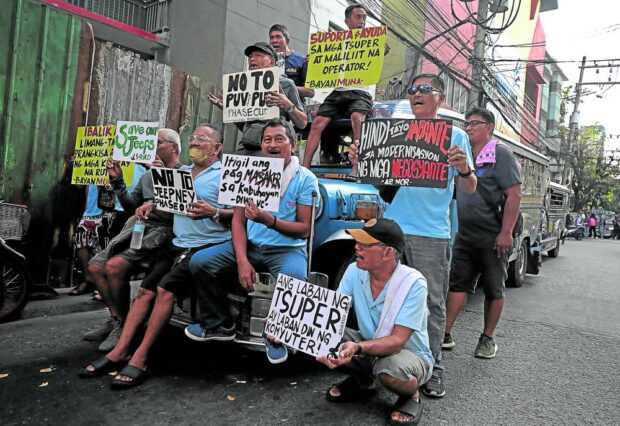 OPPOSING IMPROVEMENT  Members of the transport group Piston try to drum up support for a strike against the government’s jeepney fleet modernization program. —richard a. reyes