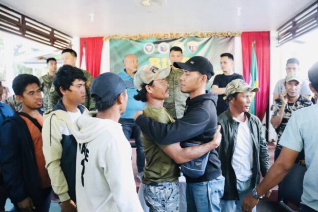 HISTORICHUG Representatives of warring clans in Basilan province give each other a hug during simple rites on Saturday inside the camp of the Philippine Army’s 64th Infantry Battalion in Barangay Tumahubong in Sumisip town after their leaders and followers signed the ceremonial peace pact and swore an oath as gestures of reconciliation to end years of conflict. —PHILIPPINE ARMY101ST BRIGADE