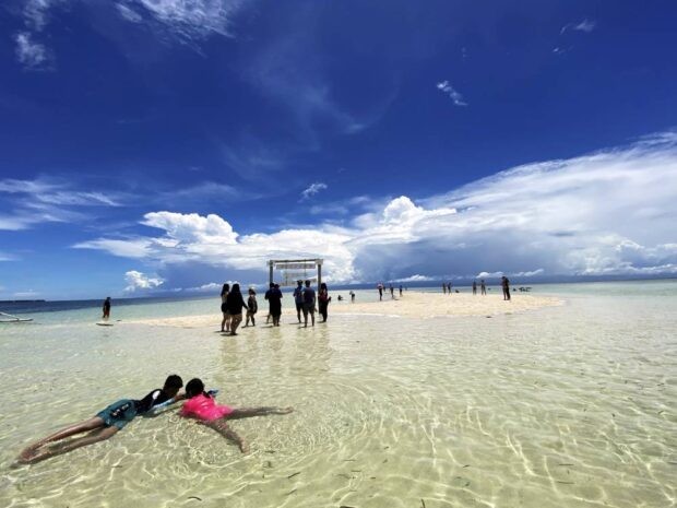 Tourists enjoy the white sand beach of Virgin Island in Panglao, Bohol, in this photo taken in August 2022. Bohol, known for its pristine environment and ecotourism destinations,is the Philippines’ first global geopark recognized by the United Nations’ cultural agency for its unique geological heritage.