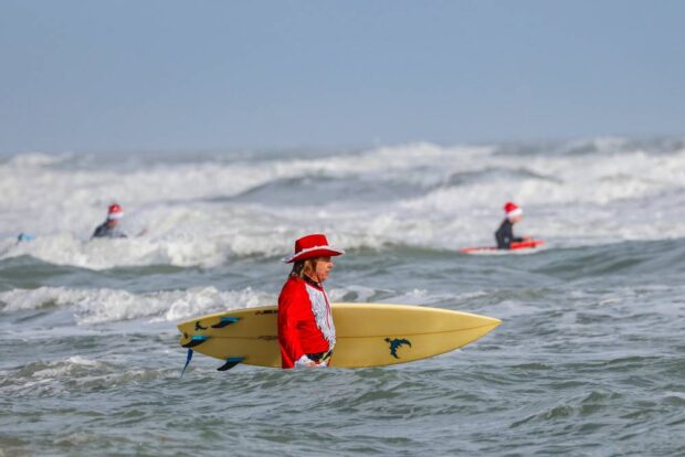 Surfersdressed as Santa ride waves during the 15th annual “Surfing Santas” event in Florida. 