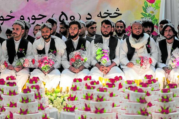 Afghan grooms look on during a mass wedding in Kabul on Dec. 25. Fifty couples were married that day in that ceremony. 