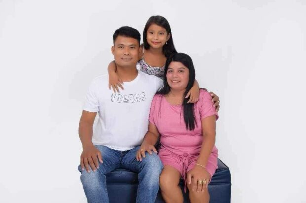 Coast Guard PO2 Philip Abellon, his wife Analyn, and their seven year-old daughter. 