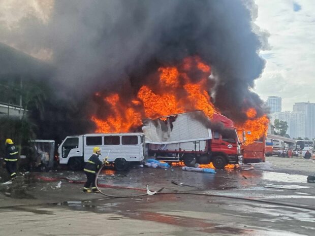 Fire engulfs a truck and bus parked at BFCT Terminal, Barangay Calumpang, in Marikina City on Sunday morning. According to the Bureau of Fire Protection, two people died and five others were injured in the incident. (Photo courtesy of Marikina Filipino - Chinese Fire Brigade Volunteers Facebook)