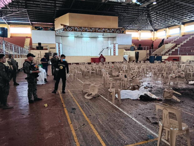 CAMPUS BECOMES TARGET Authorities secure the gymnasium of Mindanao State University (MSU) in Marawi City on Sunday, shortly after it was turned into a bloody crime scene. The university issued a statement condemning the attack, noting how it was carried out on a campus and targeted a religious ceremony attended by students, a first in MSU’s history. —Lanao Del Sur Provincial Government/REUTERS suicide bombers