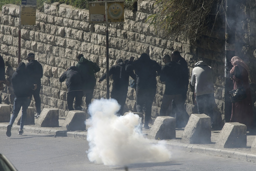 Israeli police uses tear gas to clear from the area Palestinian Muslim worshippers trying to enter the Old City for Friday prayers at the Al-Aqsa Mosque, in Jerusalem, Friday Dec. 22, 2023. (AP Photo/Mahmoud Illean)