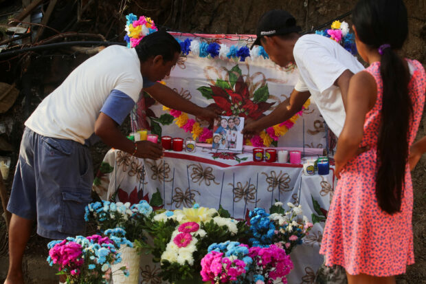Candido Trinidad de la Cruz, who lost his family and home during Hurricane Otis, places an altar in their memory, in Acapulco