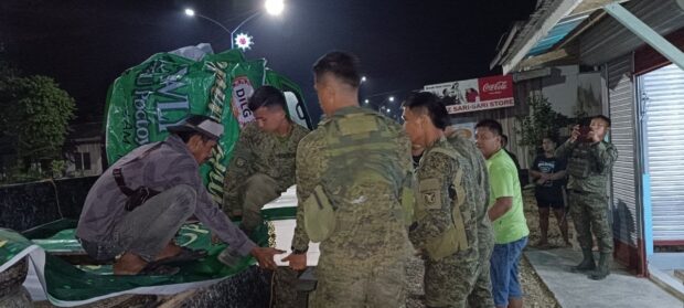 Army troops from the 67th Infantry Battalion, on Dec. 27, 2023, transfer to a truck that will bring to his family the casket that contains the remains of Joedil Virtudazo, a leader of the New People’s Army unit in Surigao del Sur, who was killed in a clash in Tagbina town on Dec. 26. 