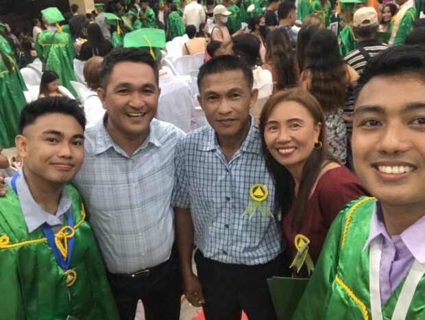 Ortiz with his family during his graduation ceremony at the Central Bicol State University of Agriculture on June 21, 2023.