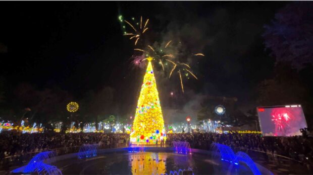 AGLOW An eight-story tall Christmas tree is lighted to the delight of the crowd during the opening of Paskuhan 2023 in Pagadian City on Friday. They were unaware of the online bomb joke being spread while the event was being streamed live on Facebook. —LEAH AGONOY