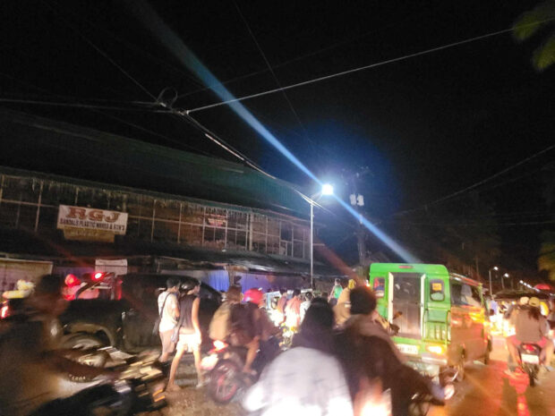 People evacuate following an earthquake, in Hinatuan, Surigao del Sur, on December 2, 2023. 