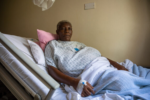 Uganda woman, Safina Namukwaya, 70, sits on a hospital bed at the Women’s Hospital International and Fertility Center after giving birth in Kampala on December 03, 2023. 