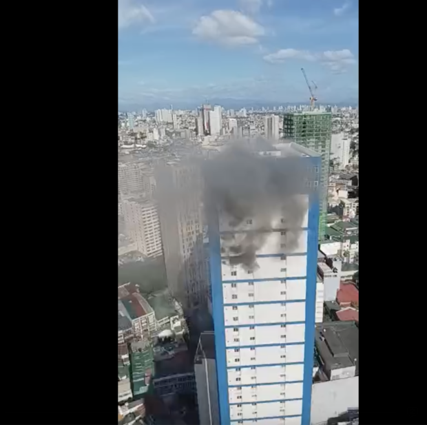 Fire burns in a high-rise condominium in Binondo, Manila