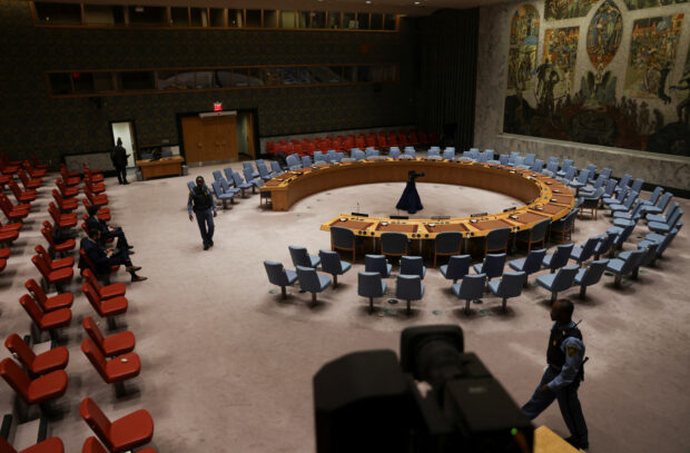 Security personnel walk at the United Nations Security Council chamber before a meeting to vote to demand aid access for Gaza