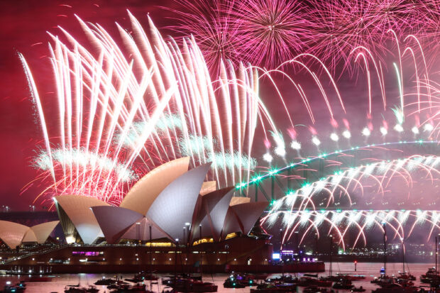 New Year’s Eve fireworks light up the sky over the Sydney Opera House (front) and Harbour Bridge during the fireworks display in Sydney on January 1, 2023 for story: World prepares to ring in 2024