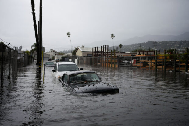 Cars are submerged on a flooded street during a rain storm, Thursday, Dec. 21, 2023, in Santa Barbara, California. (AP)