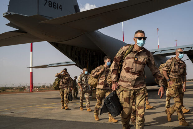 FILE - French soldiers disembark from a U.S. Air Force C130 cargo plane at Niamey, Niger base, on June 9, 2021. France on Friday Dec. 22, 2023 completed the withdrawal of its troops who were asked to leave Niger by the country’s new junta, ending years of on-the-ground military support and raising concerns from analysts about a gap in the fight against jihadi violence across Africa’s Sahel. (AP Photo/Jerome Delay, File)
